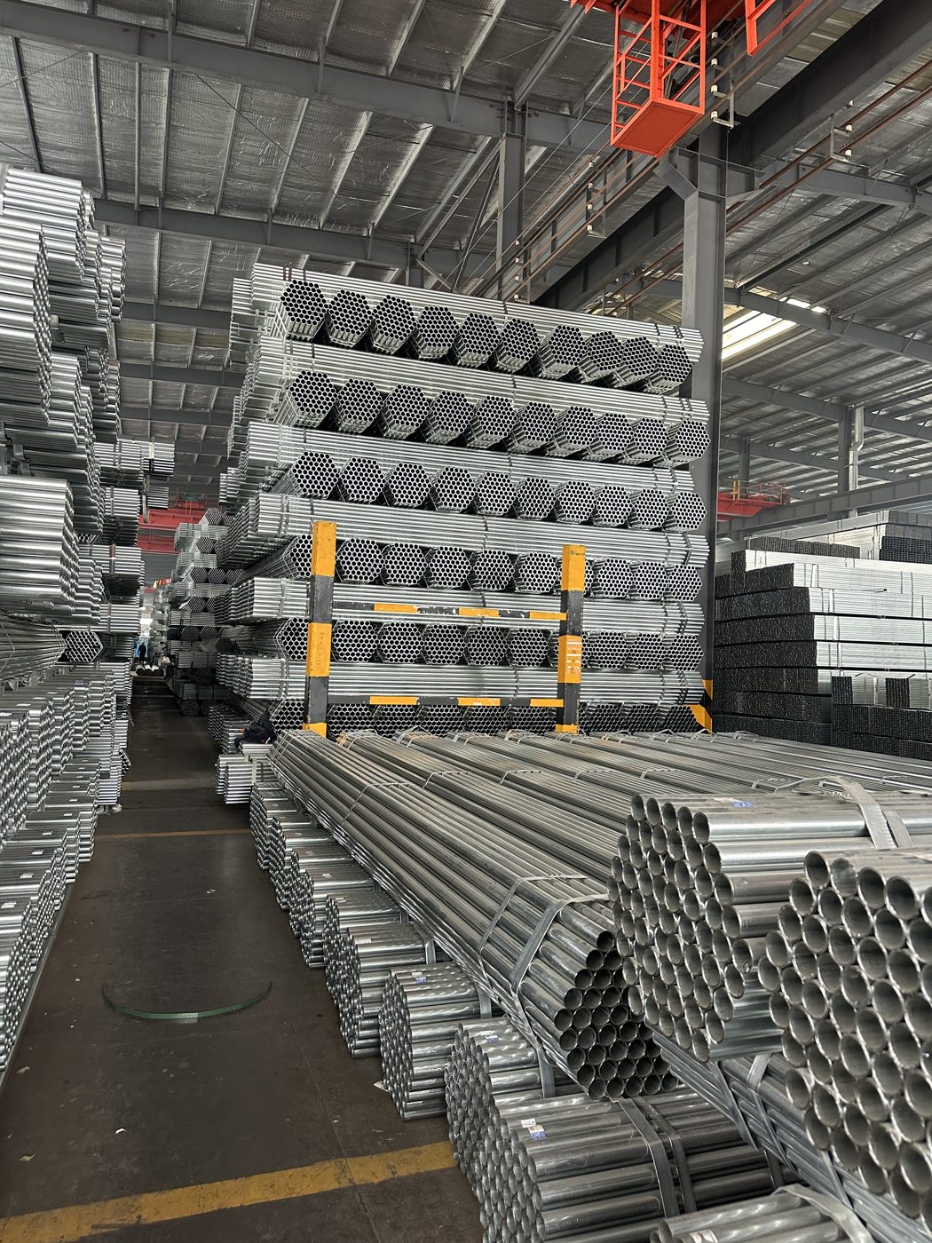 GI pipes stacked in warehouse